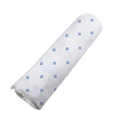 Angled view of the Periwinkle Diamond Polka Dot swaddle blanket neatly rolled up.