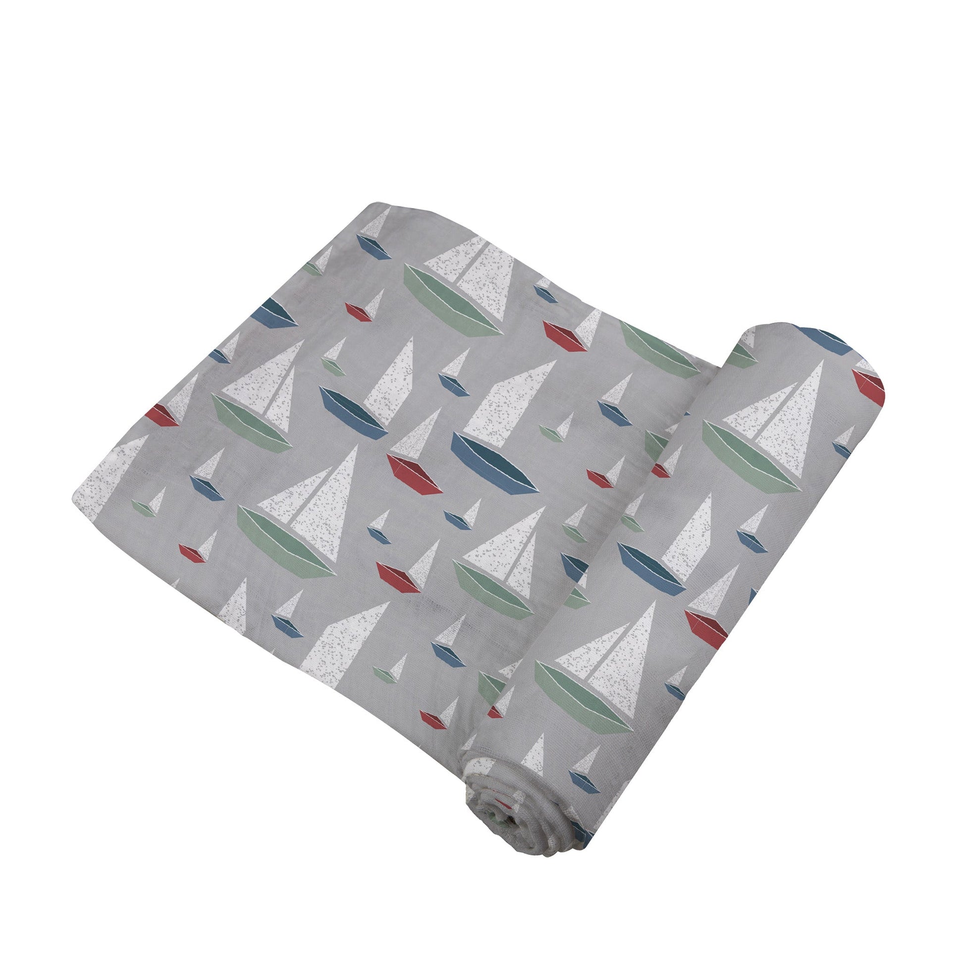 Angled view of the grey swaddle blanket with colorful sailboats partially unrolled to show its soft texture.