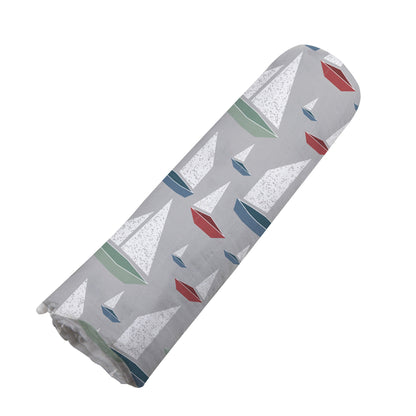 Angled view of the Marina Sailboats bamboo muslin swaddle blanket neatly rolled up into a cylinder.