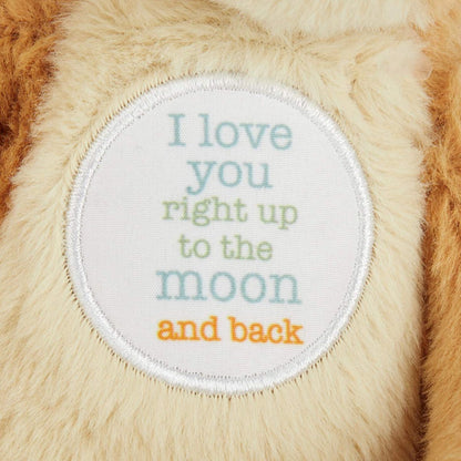 A close-up shot of the white circular patch embroidered with the text I love you right up to the moon and back.