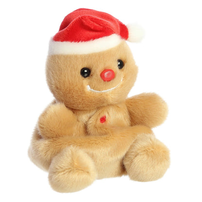 Aurora 5-inch Palm Pals Gingy Gingerbread plush toy sitting at an angle showing its golden-brown cookie body, plush red Santa hat, white icing smile, and a round red nose.