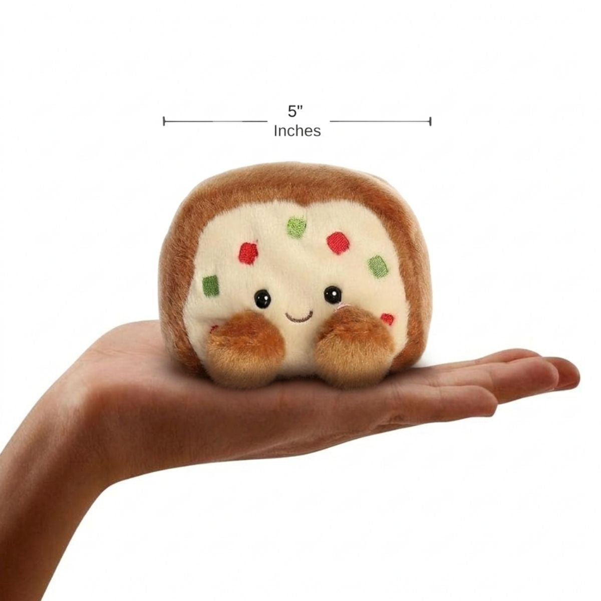 The miniature Fran Fruit Cake plush sitting balanced in an open human hand under a 5-inch height graphic indicator.