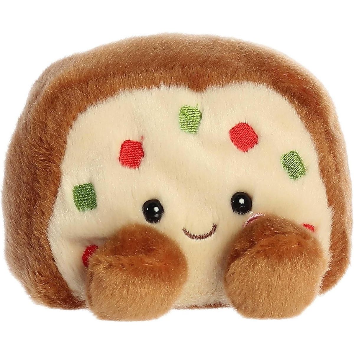 Aurora 5-inch Palm Pals Fran Fruit Cake plush toy showing its warm brown crust, cream-colored cake face with red and green embroidered fruit pieces, a sweet smile, and tiny brown feet.