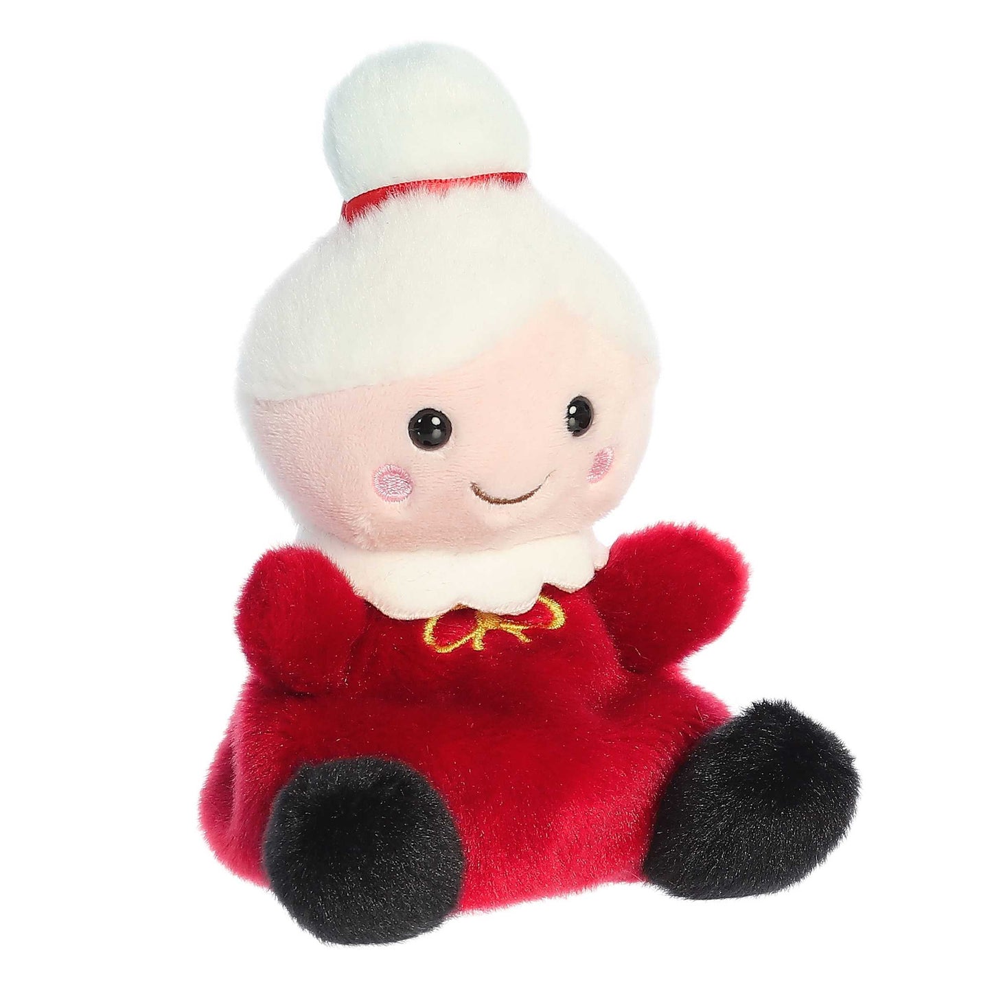 Aurora 5-inch Palm Pals Mrs. Claus plush toy sitting at an angle showing her crimson-red dress, white collar with gold embroidery, and snow-white hair styled in a bun with a red band.