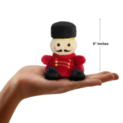 The miniature Marius Nutcracker plush sitting balanced in an open human hand under a 5-inch height graphic indicator.