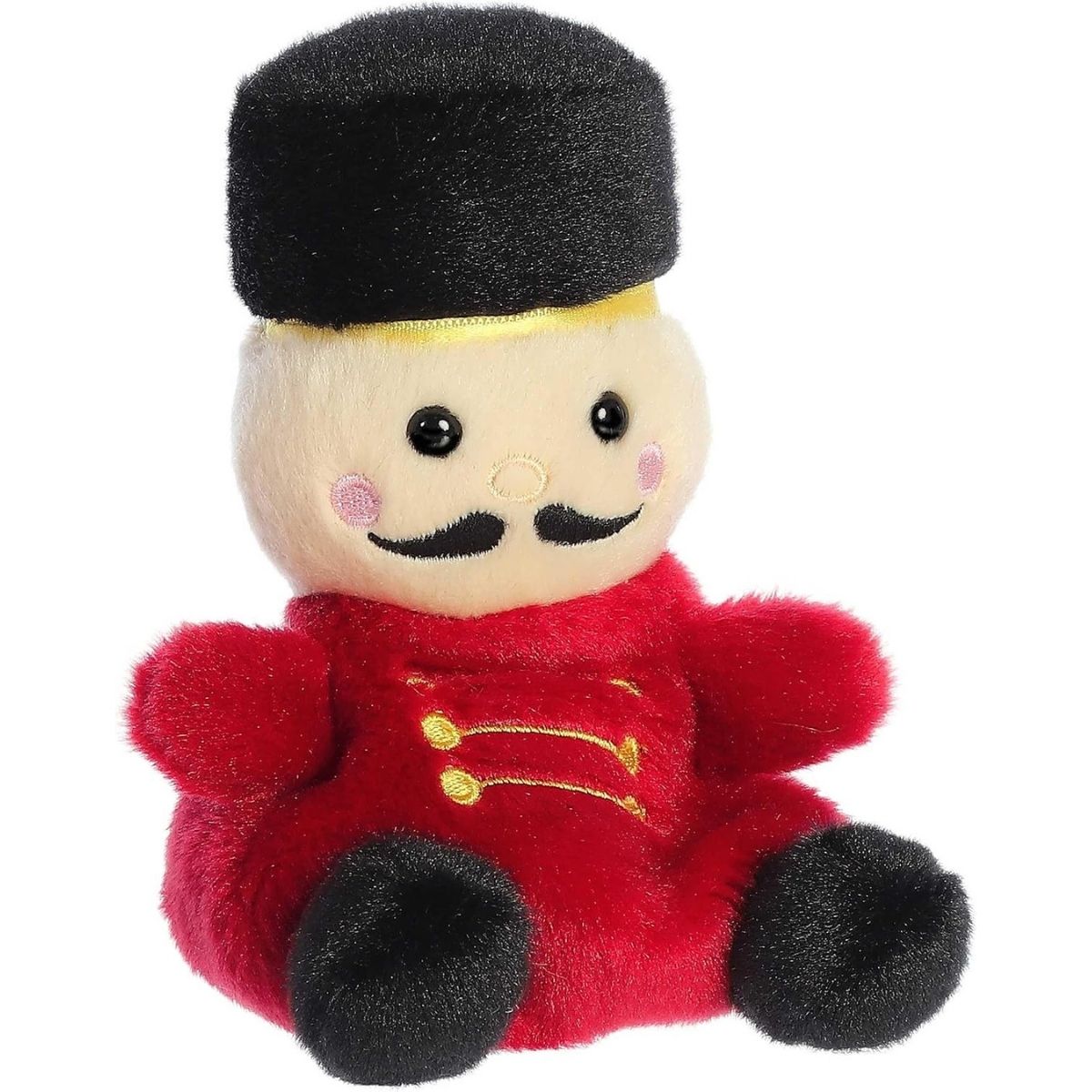 Aurora 5-inch Palm Pals Marius Nutcracker plush toy sitting at an angle showing its red uniform coat with gold stitching, tall black hat, and prominent black handlebar mustache.