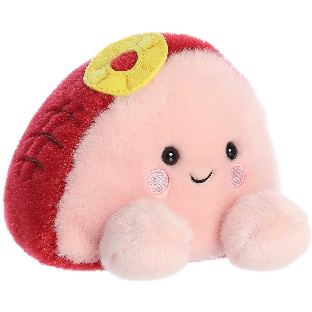 Aurora 5-inch Palm Pals Virginia Ham plush toy showing its light pink face, deep maroon-red outer glaze with diamond scoring marks, and a yellow plush pineapple ring on top.