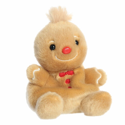 Aurora Palm Pals Gino 5-inch Gingerbread Man plush stuffed toy sitting forward with golden-brown fur and a red bow tie.