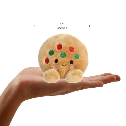 The miniature Kringle Cookie plush sitting inside an open human hand displaying a 5-inch width indicator graphic.
