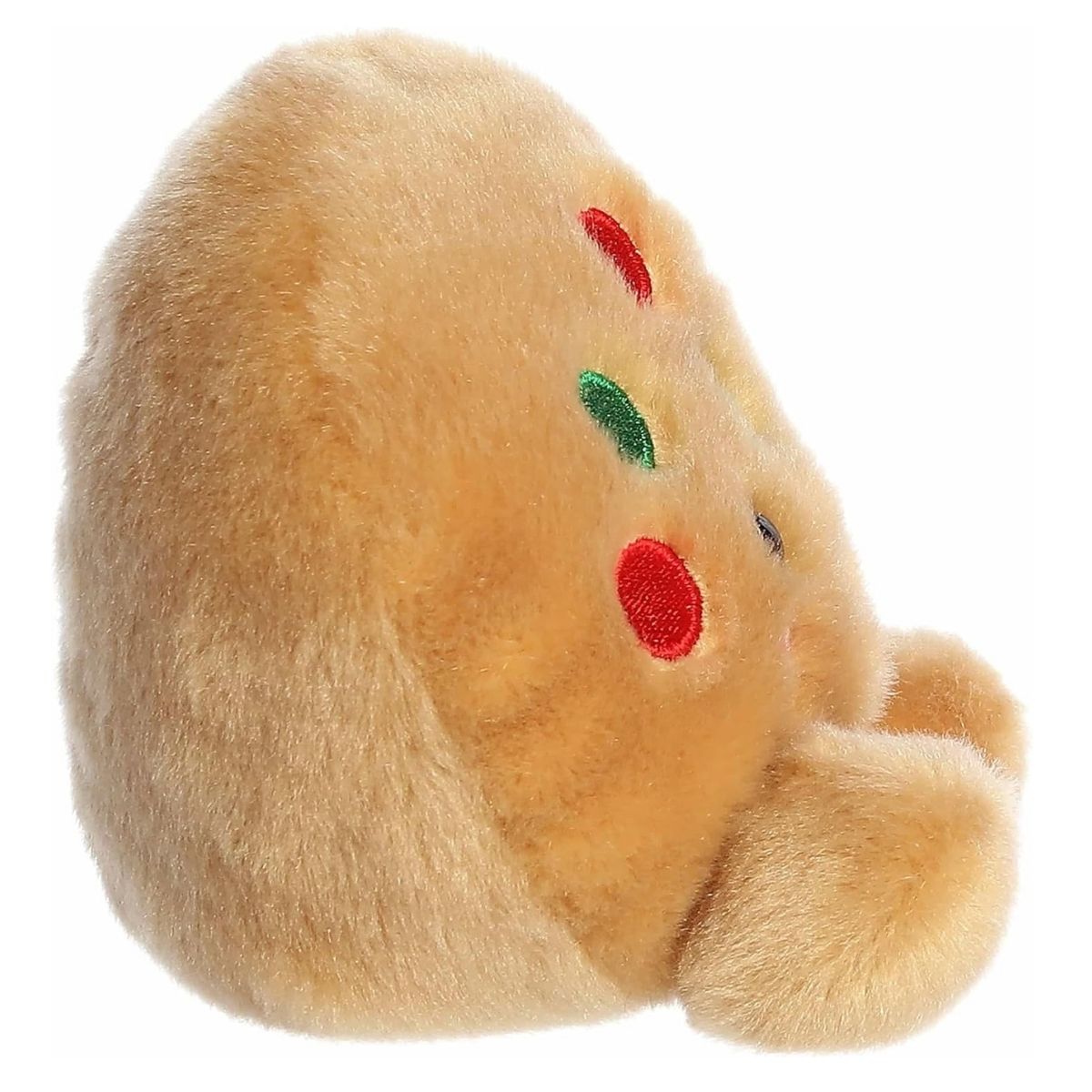 The right side profile view of the sitting Aurora Palm Pals holiday cookie plush highlighting its round, plump shape