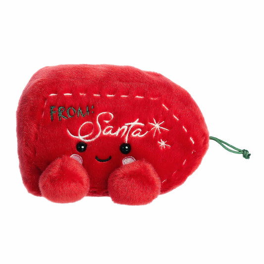 Red plush toy with a smiling face and 'From Santa' text on a white background
