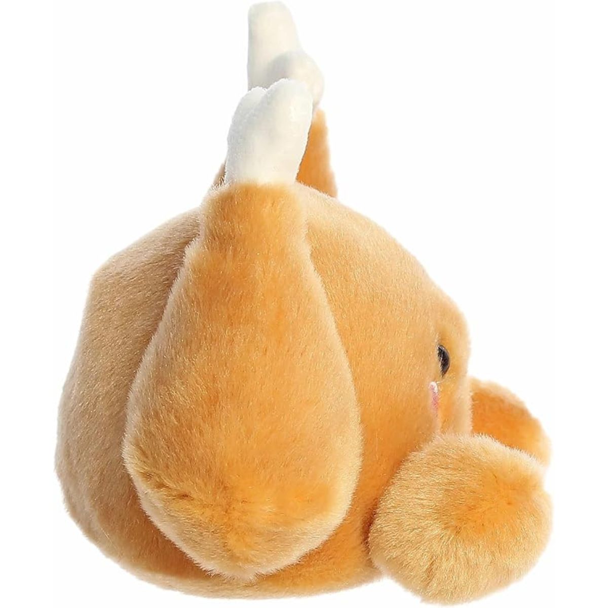 The right side profile view of the sitting Aurora Palm Pals turkey plush highlighting its rounded roasted body shape.