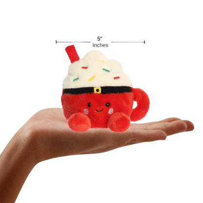 The miniature Klaas Santa Cocoa plush sitting balanced in the palm of an open human hand under a 5-inch height graphic indicator.