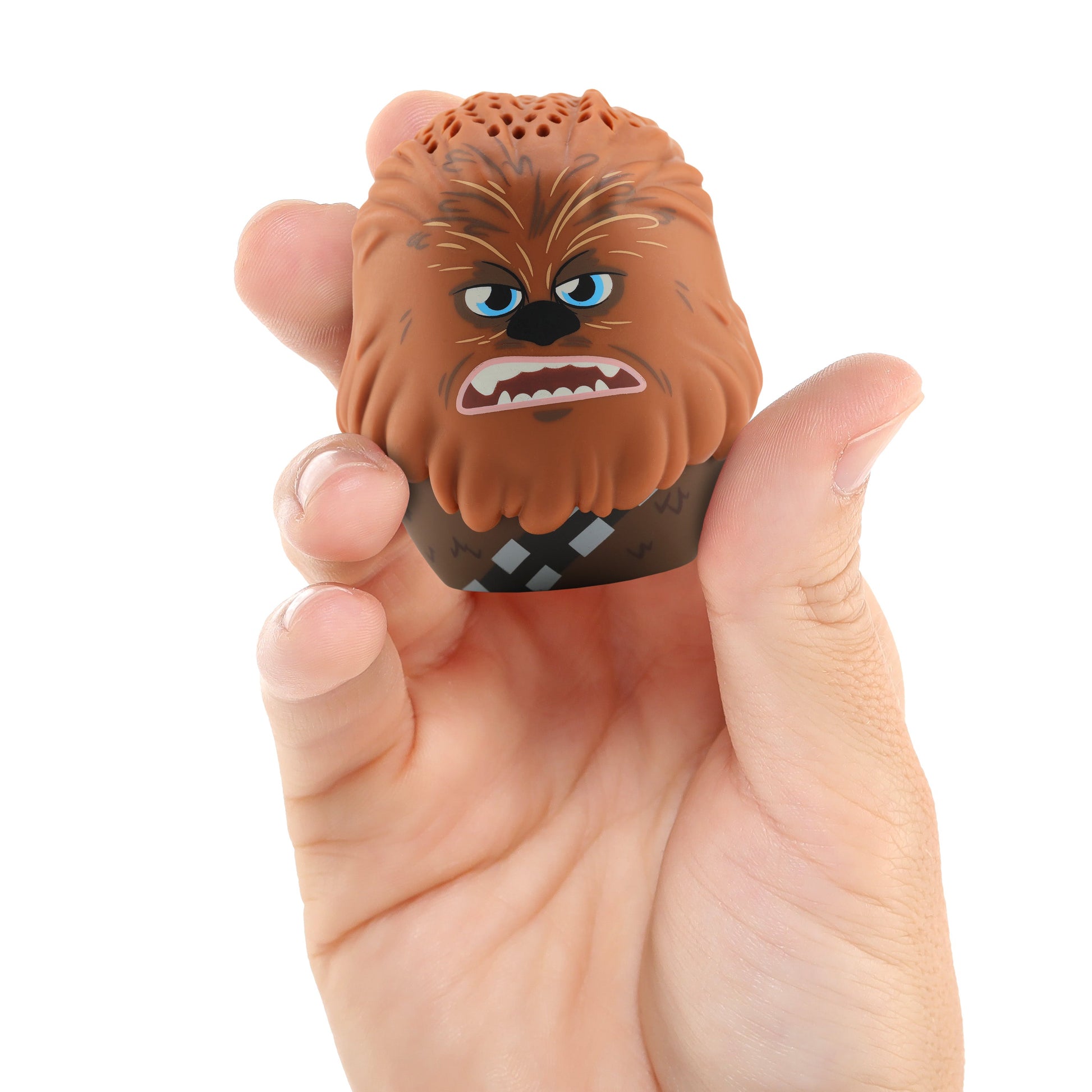 A hand holding the Bitty Boomers Chewbacca mini Bluetooth speaker, demonstrating its ultra-portable, 2-inch pocket-sized design.
