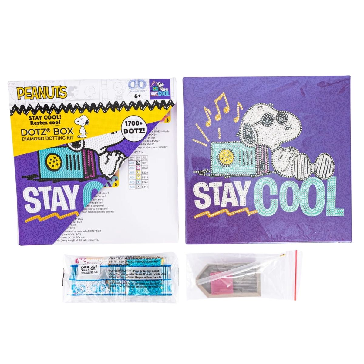 Contents of the Diamond Dotz Box kit, including the Peanuts Snoopy canvas box, colorful diamond drills, stylus tool, wax, and craft tray.