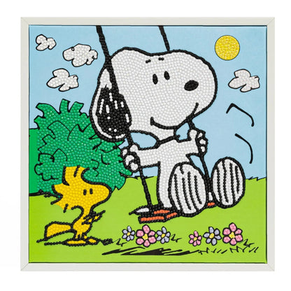 Straight-on view of the completed 9.4 by 9.4 inch Peanuts diamond painting showing its white border and bright outdoor background.