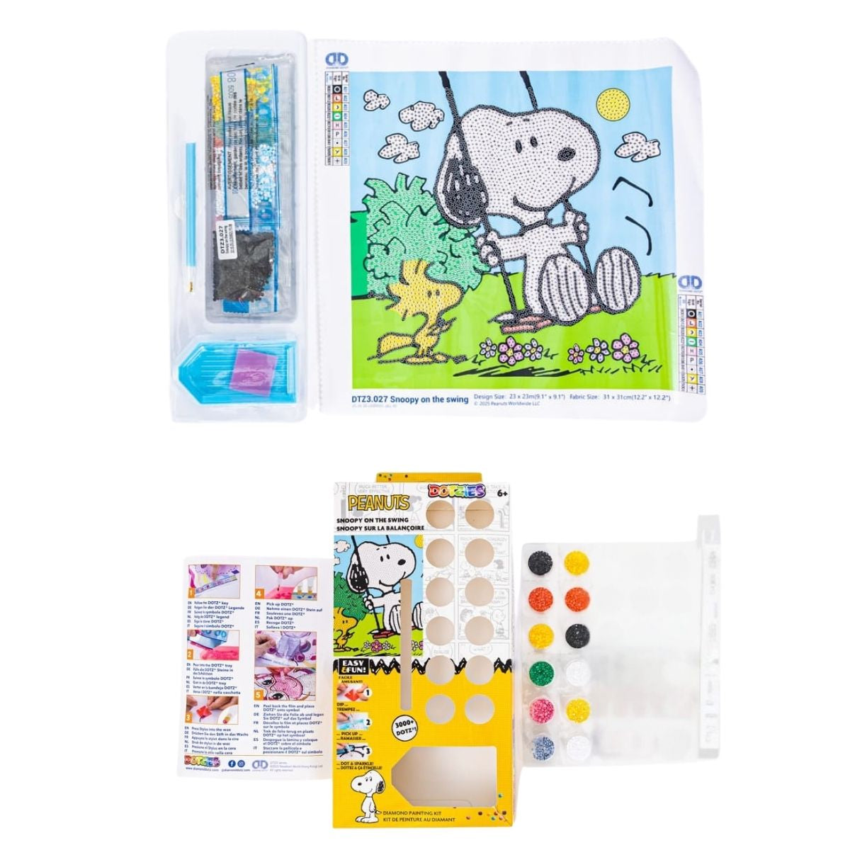 Retail packaging and contents of the DIAMOND DOTZ Peanuts Snoopy on the Swing kit, including the canvas, colorful diamond drills, stylus tool, and craft tray.