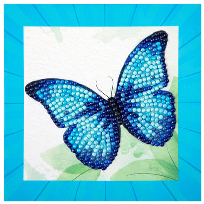 Finished DIAMOND DOTZ Blue Butterfly diamond painting featuring sparkling azure and navy wings with a bright blue border.