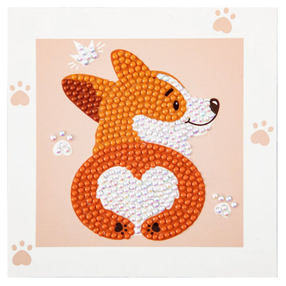 Finished DIAMOND DOTZ Corgi Love diamond painting featuring a smiling corgi with a heart-shaped bottom on a peach background with paw prints.