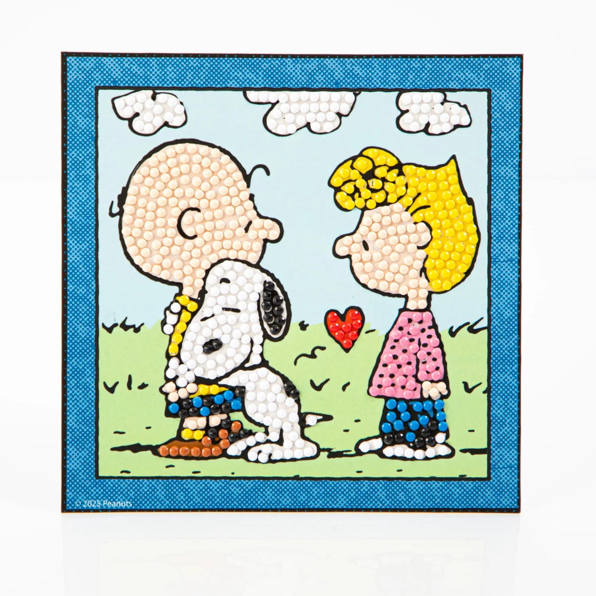 Straight-on view of the completed 5.1 by 5.1 inch Peanuts diamond painting showing its blue border and outdoor background.
