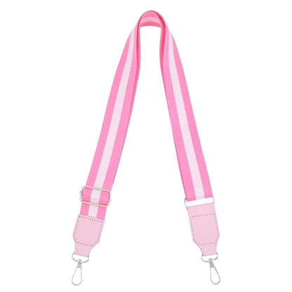 Full view of the adjustable pink and white striped wide woven crossbody strap equipped with silver metal lobster clasps.