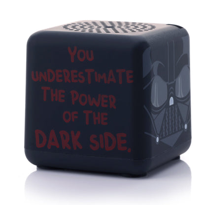 Angled left view of the square Darth Vader mini speaker showing the phrase 'YOU UNDERESTIMATE THE POWER OF THE DARK SIDE' written in red font.