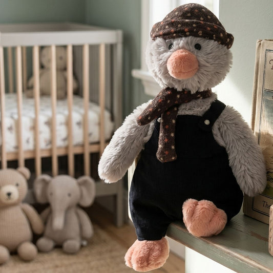 Happy Horse Penguin Polar dressed plush toy sitting on a shelf in a modern nursery next to a wooden crib and plush elephant.
