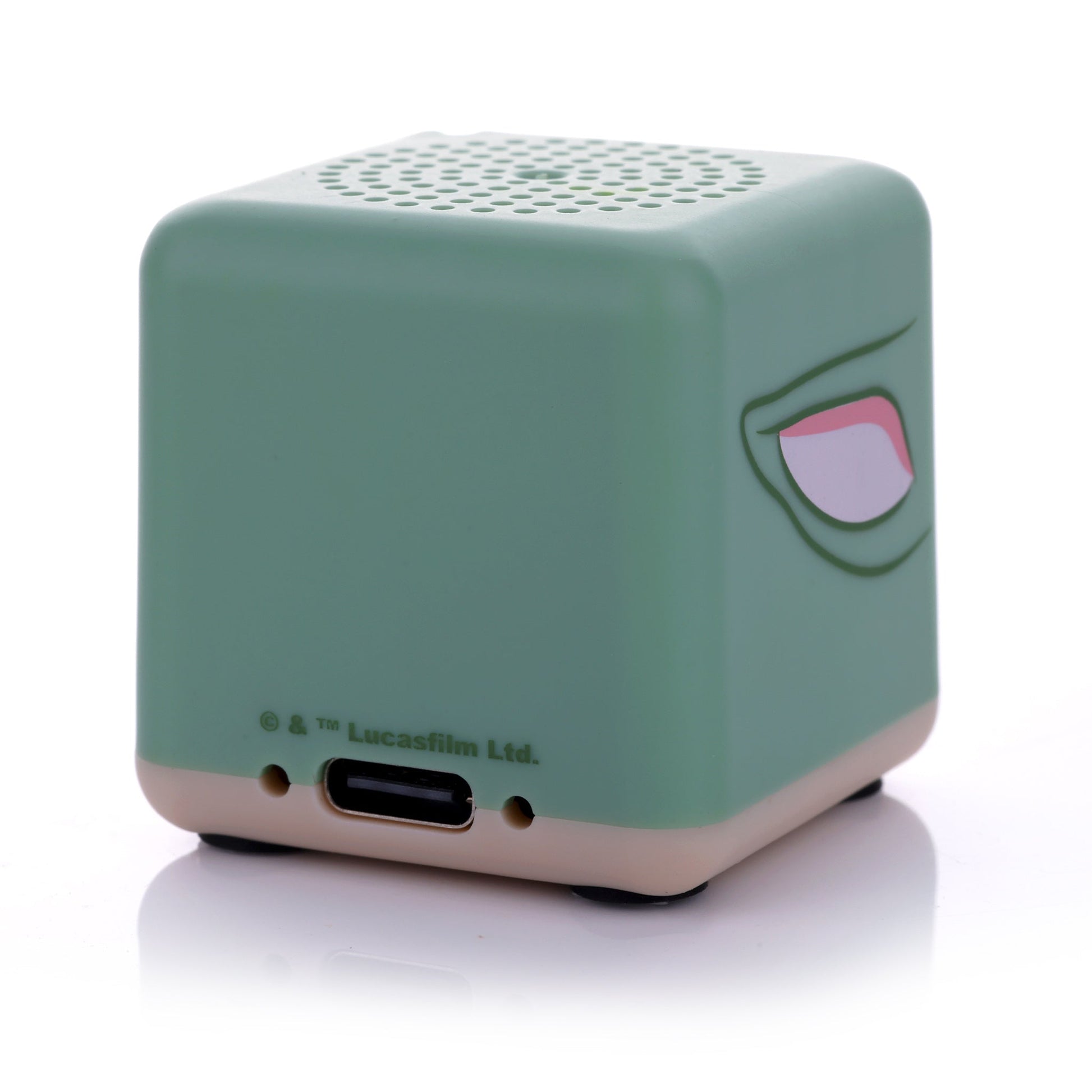 Angled back view of the Grogu Bitty Box speaker showing the smooth green surface and lower charging port.