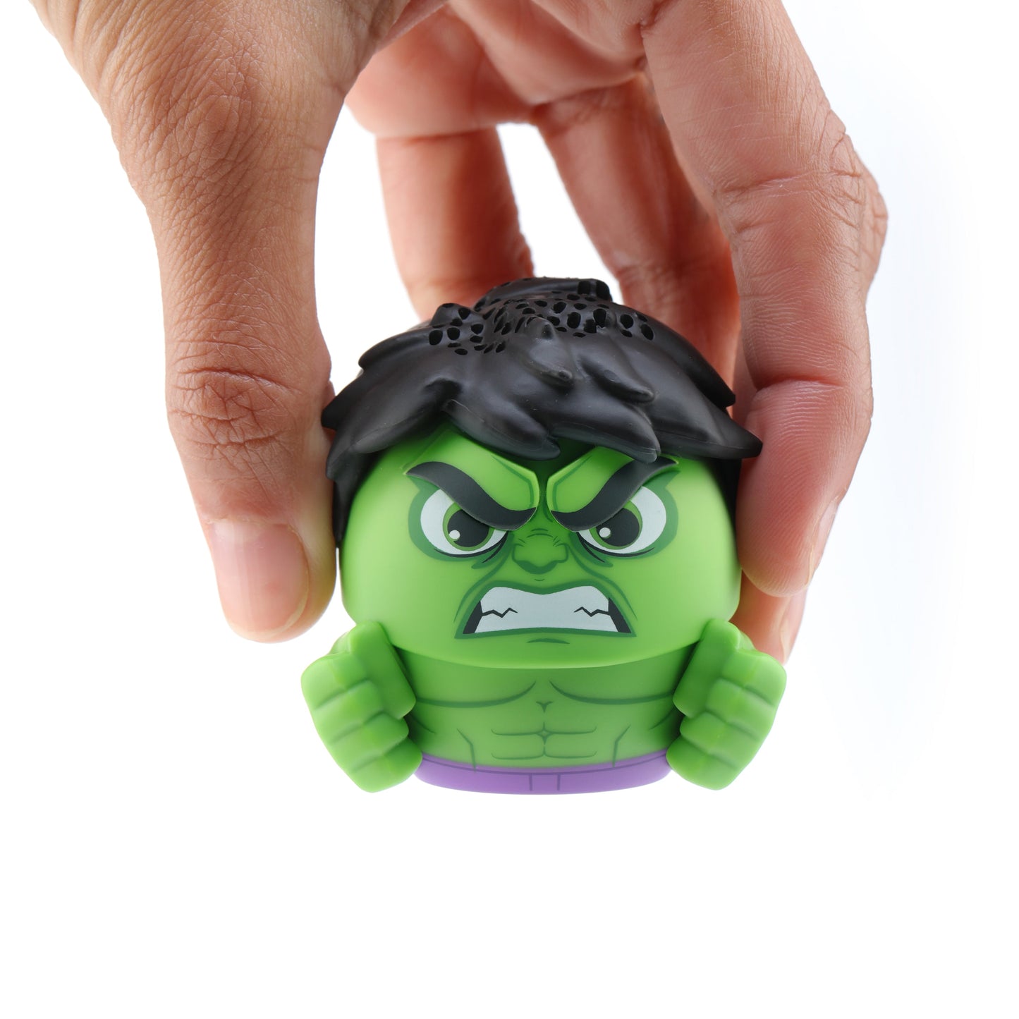 A hand picking up the Hulk Bluetooth speaker from above, showing its small scale against a white background.