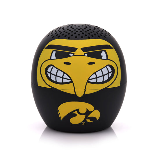 Front view of the Bitty Boomers NCAA Iowa Hawkeyes mini Bluetooth speaker featuring a fierce yellow Herky the Hawk face and a black base with the official Iowa logo.