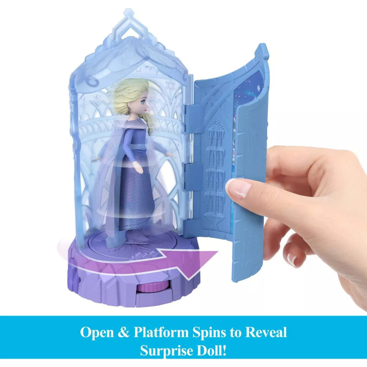 Toy figure in a blue and purple display case with text 'Open & Platform Spins to Reveal Surprise Doll!'.