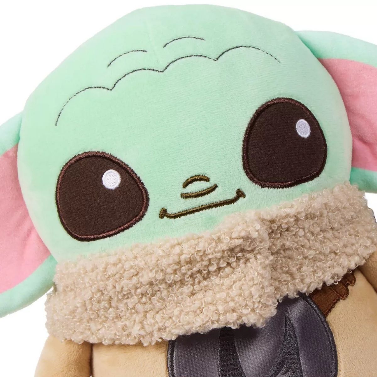 Close-up of Grogu’s face highlighting the embroidered details, large black eyes, and fluffy sherpa collar texture.