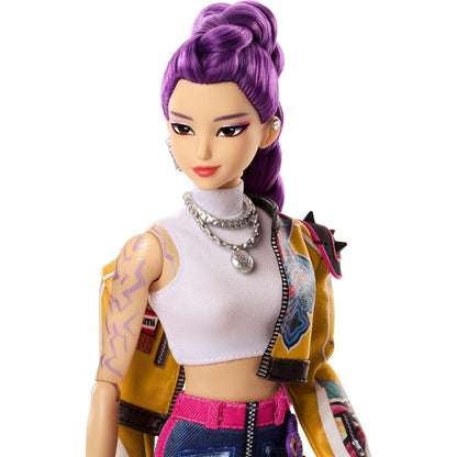 A close-up shot of the 12-inch Rumi fashion doll showcasing her signature high purple ponytail, detailed makeup, and arm tattoo print.