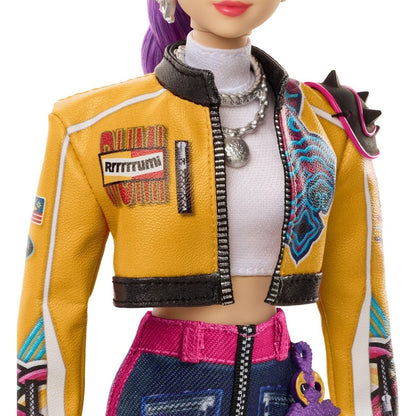 Close-up view of the K-Pop Demon Hunter Rumi doll's cropped yellow graphic jacket and layered silver chain necklaces.