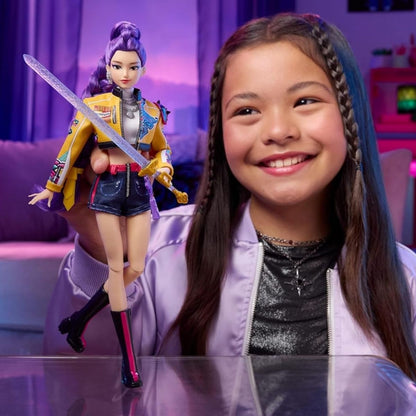 A young girl smiling while playing with and posing the articulated K-Pop Demon Hunter Rumi doll.