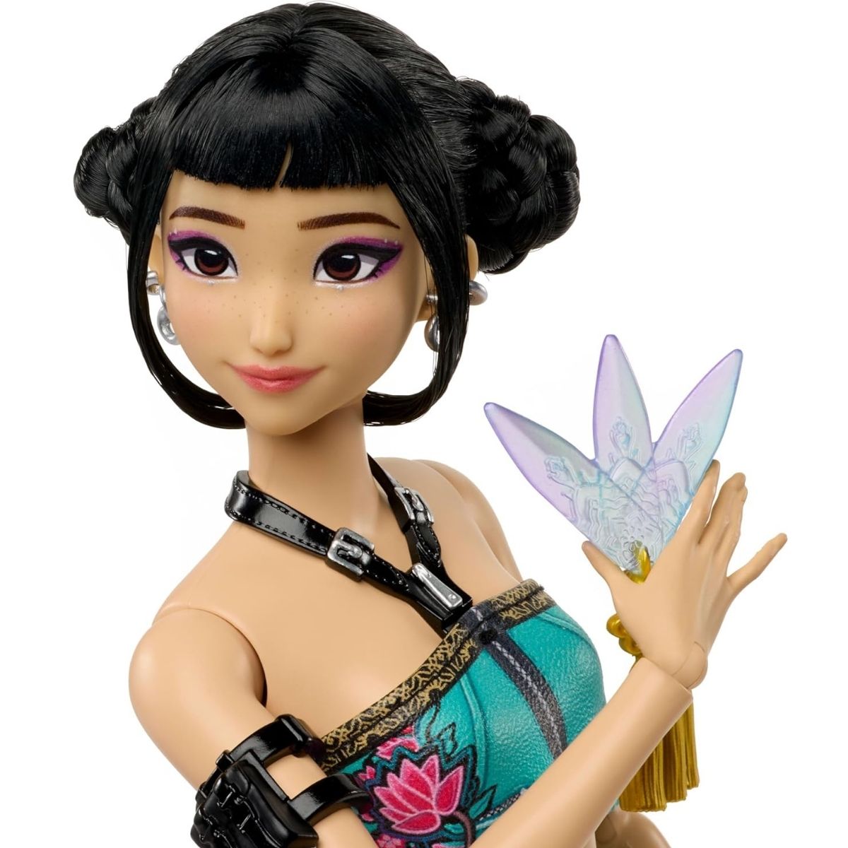 A close-up shot of the 12-inch Zoey fashion doll showcasing her signature black space buns up-do and holding a translucent purple spirit blade accessory.