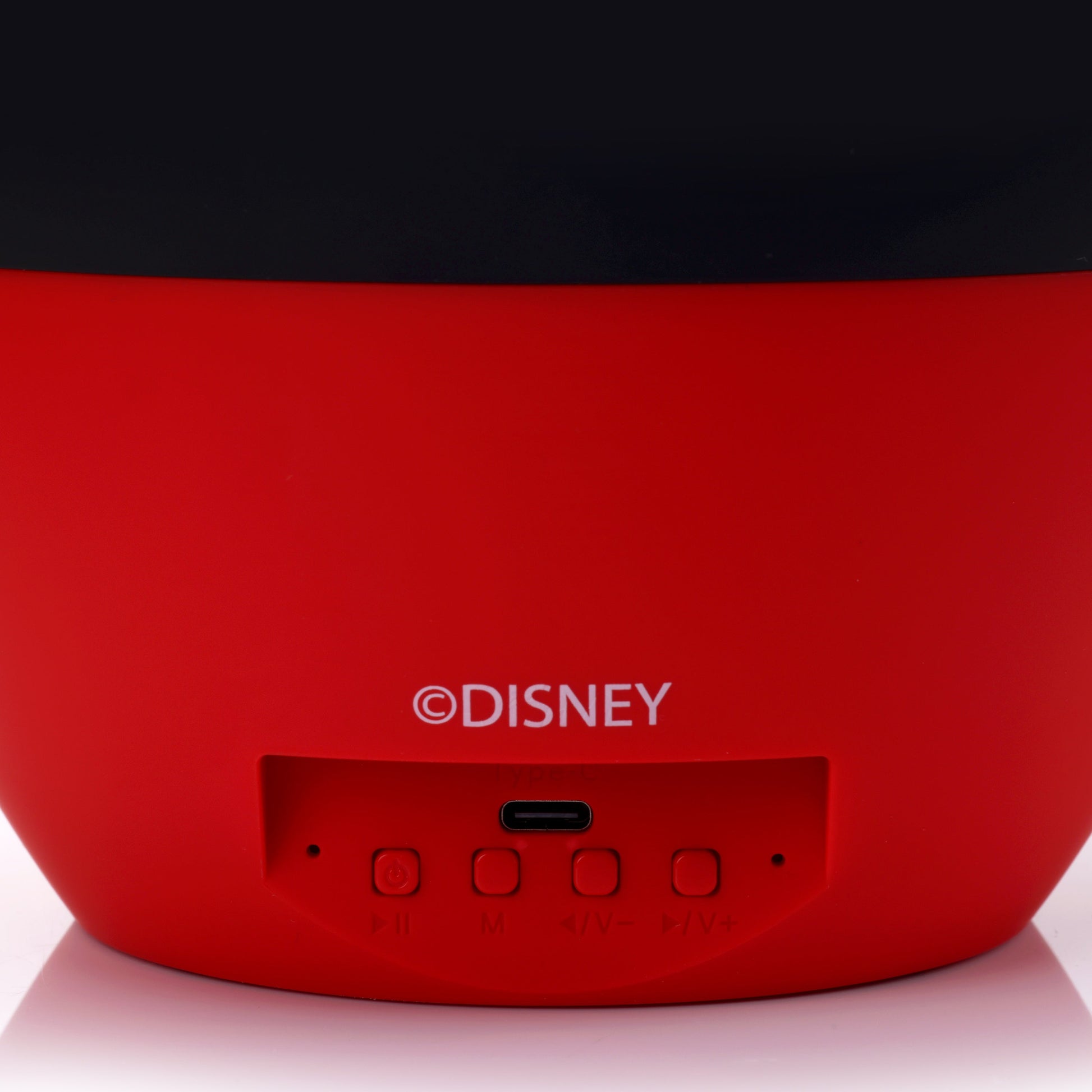 Close-up view of the back of the Mickey speaker showing the power controls, charging ports, and official Disney copyright.