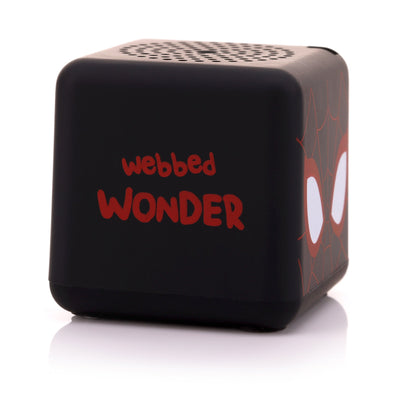 Angled left view of the square Miles Morales mini speaker showing the phrase 'Webbed WONDER' written in red font.