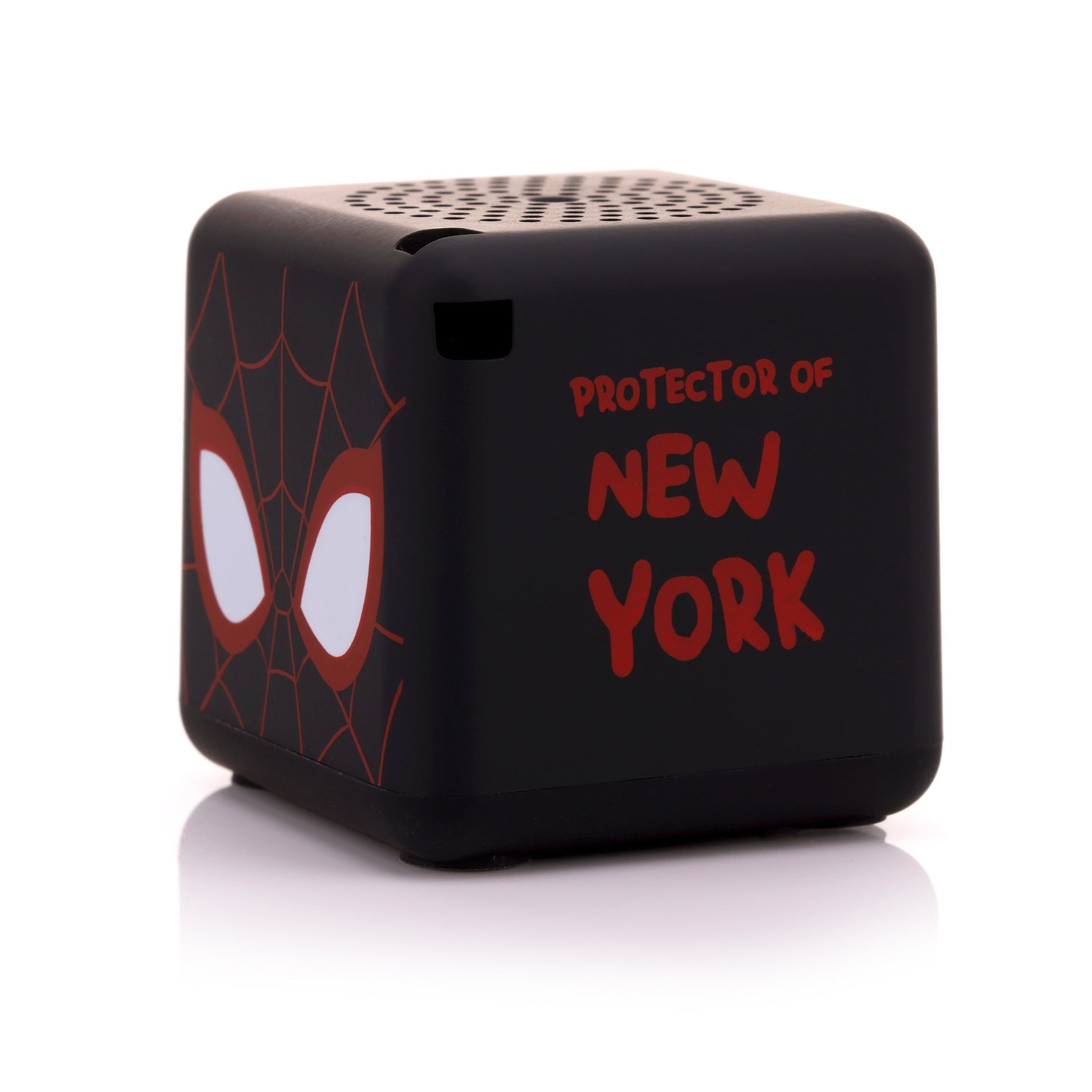 Angled back-right view of the black Spider-Man Bluetooth speaker showing the phrase 'PROTECTOR OF NEW YORK' written in red font.