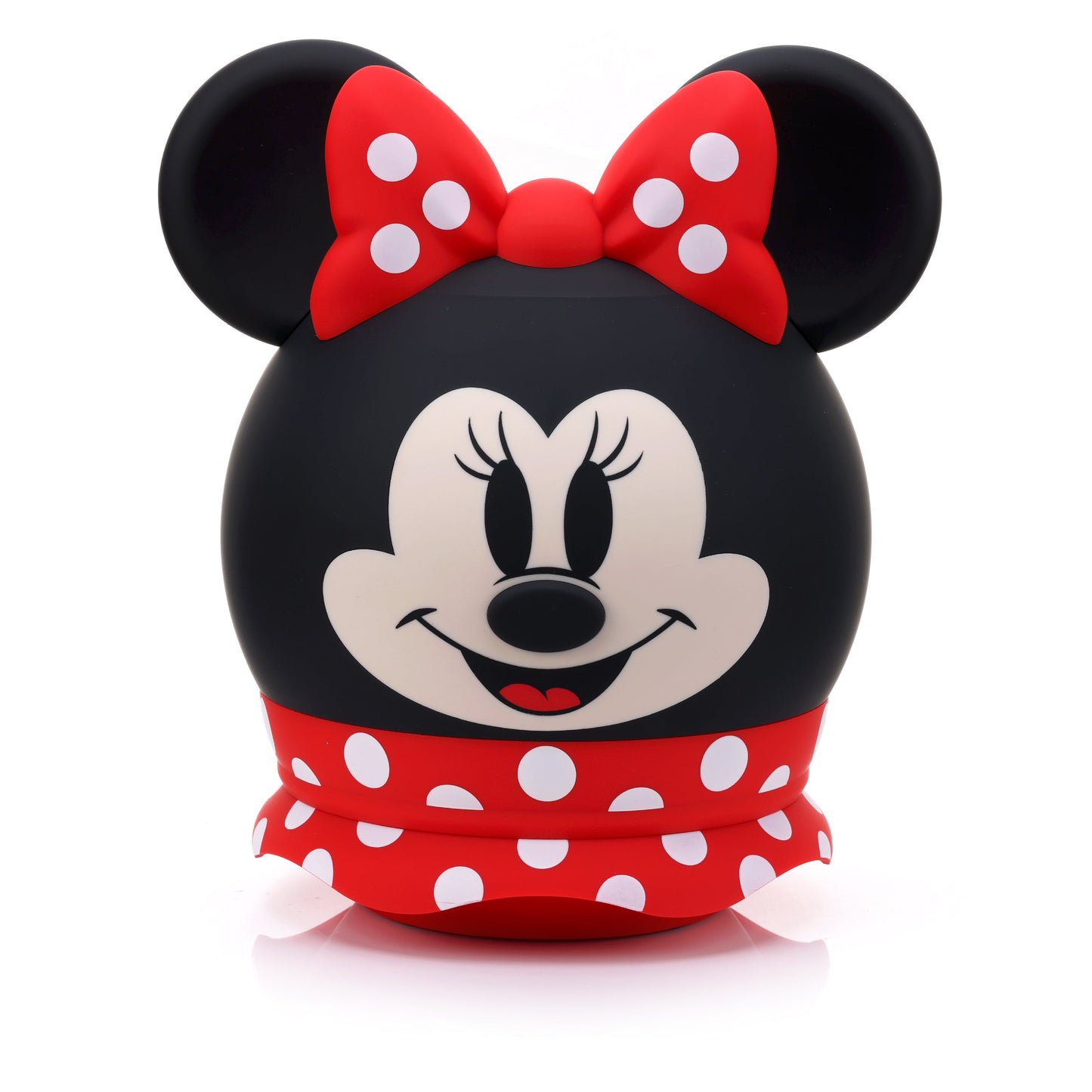 Front view of the Bitty Boomers Disney Minnie Mouse 8-inch Bluetooth speaker featuring her smiling face, a red polka dot bow, and a red ruffled skirt base.