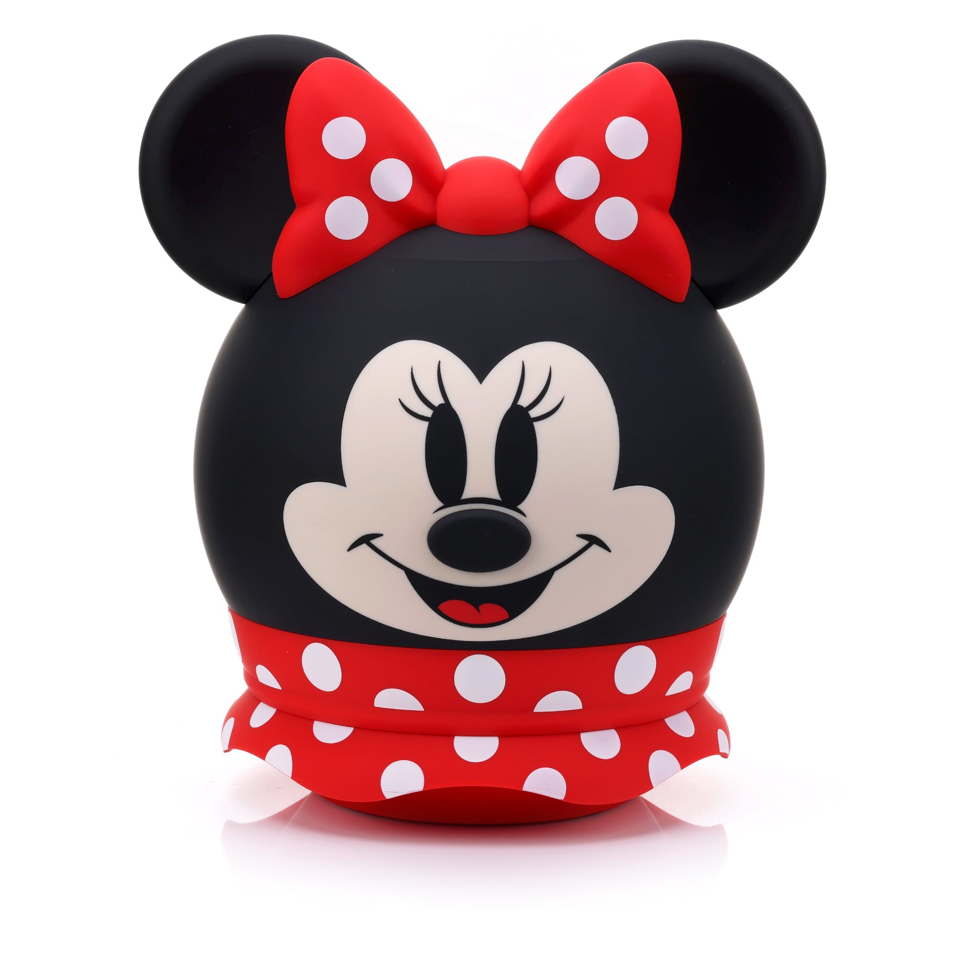 Front view of the Bitty Boomers Disney Minnie Mouse 8-inch Bluetooth speaker featuring her smiling face, a red polka dot bow, and a red ruffled skirt base.