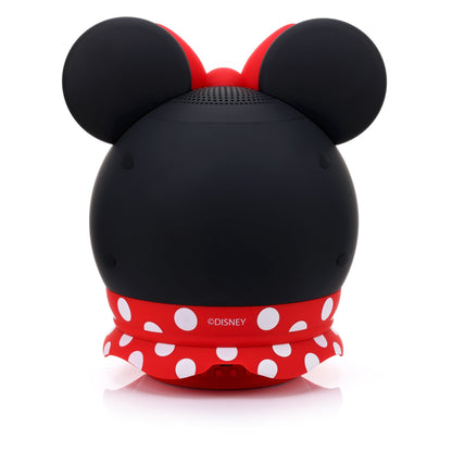Back view of the Minnie Mouse speaker showing the solid black back, red polka dot skirt, and lower charging port.