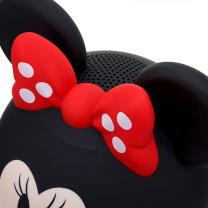 Close-up view of the top of the speaker highlighting the textured red and white polka dot bow and the top speaker grill.