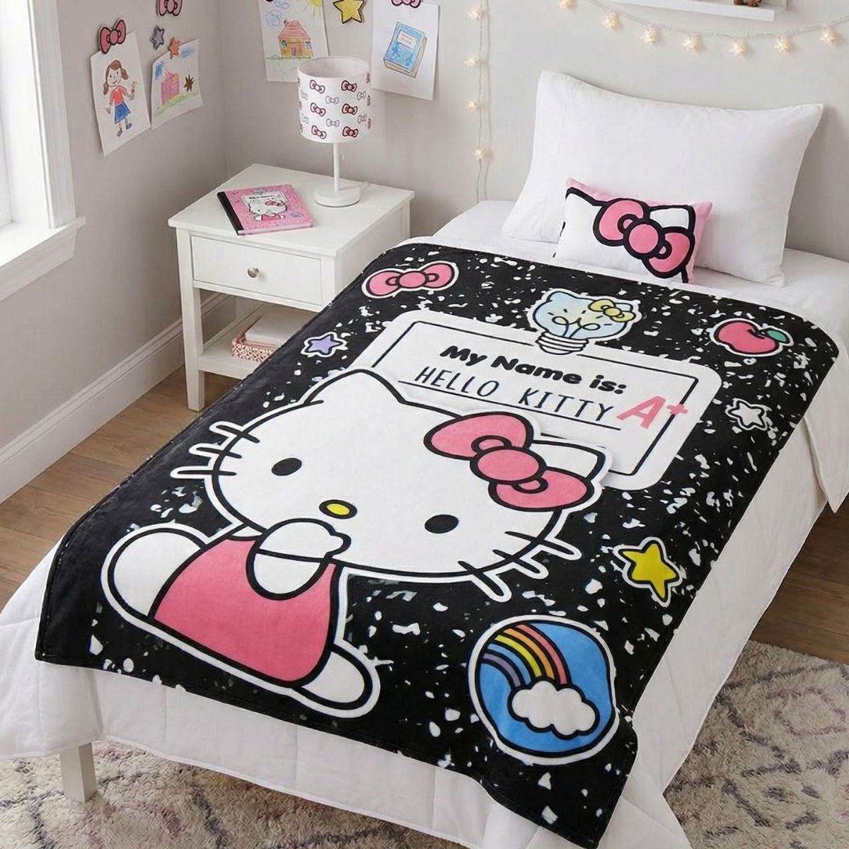Lifestyle bedroom shot showing the Hello Kitty composition notebook blanket draped beautifully over a bed.