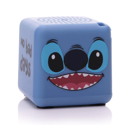Front view of the blue cube-shaped Bitty Boomers Disney Stitch Bitty Box mini Bluetooth speaker featuring a wide, smiling Stitch face.