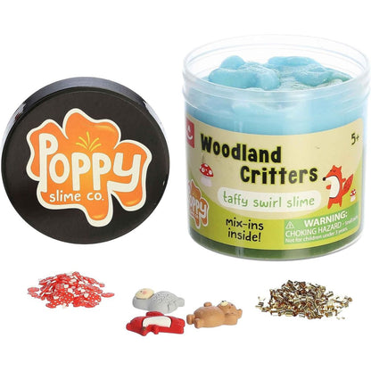 Front view of the Woodland Critters slime jar next to its black lid featuring the orange Poppy Slime Co. logo, with loose mix-in pieces scattered in front.