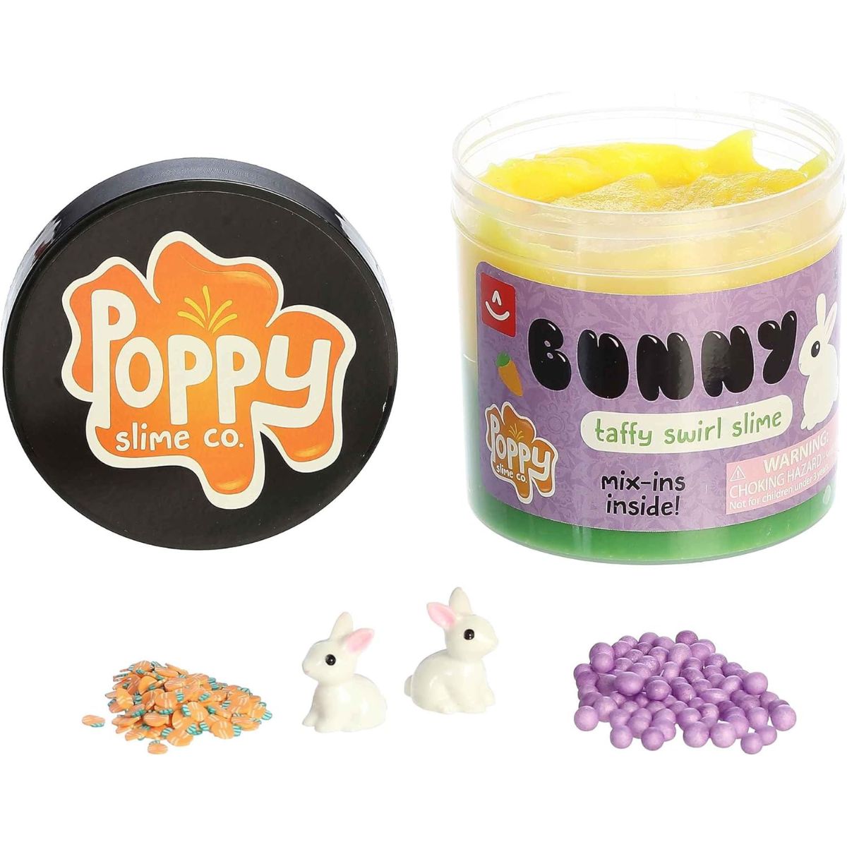 The Bunny Taffy Swirl Slime container with its black Poppy Slime Co. lid removed, sitting next to small piles of purple sprinkles, orange beads, and bunny mix-ins.