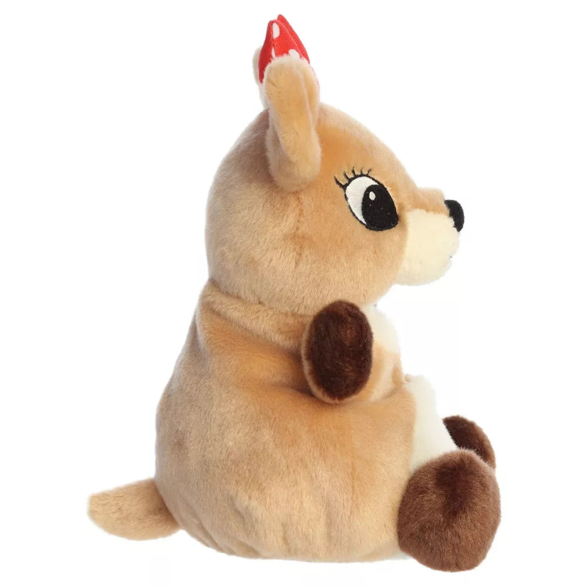 Side profile view of Aurora Clarice 8-inch plush showing upright seated posture, red polka dot bow, and small tail.