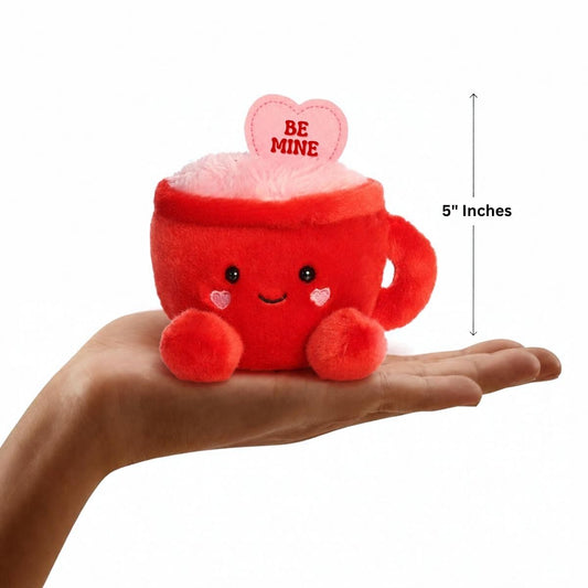 Aurora Palm Pals 5-inch Be Mine Latte plush resting in the palm of an open hand.