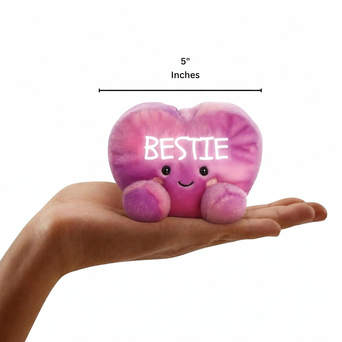 Aurora Palm Pals 5-inch Bestie Candy Heart plush resting in the palm of an open hand.